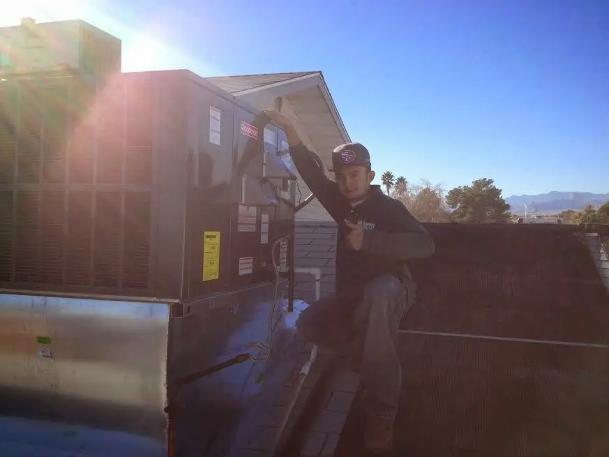 HVAC technician performing HVAC Inspection on a rooftop unit in Shorewood